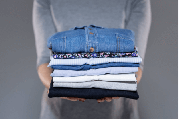 different clothing fabrics held in woman's hands